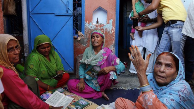 Relatives mourn the killing of Mohammad Akhlaq at his home in India.