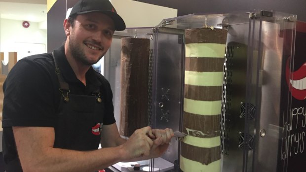 Ned Russell prepares a dessert kebab by shaving chocolate off a 10 kilogram, rotating block. 