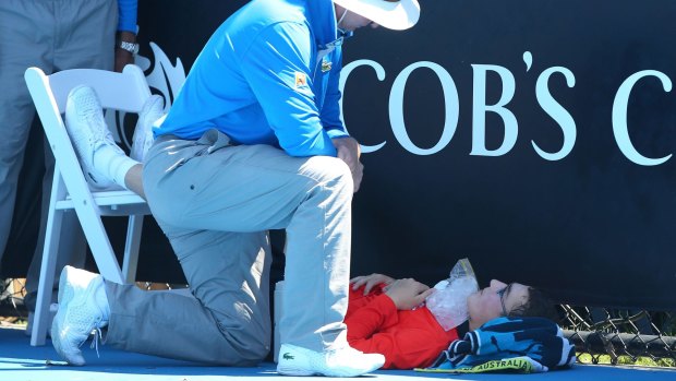 Flashback: A ballboy faints in the heat, as Melbourne heads towards 43 degrees celsius during day two of the 2014 Australian Open.