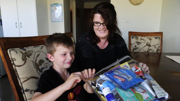 Grace Stephenson with her son Koda, six, with one of the blessing bags they have created.