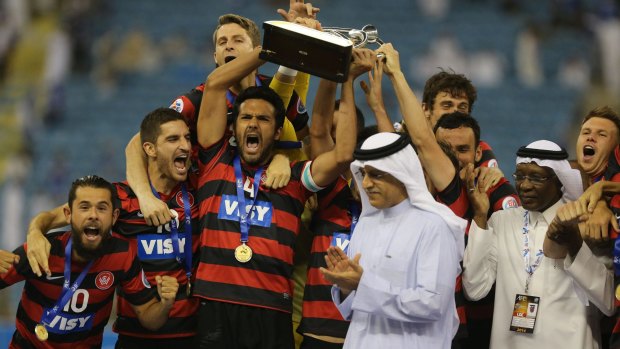Canberra product Nikolai Topor-Stanley holds aloft the AFC Champions League trophy after leading the Wanderers to victory. 