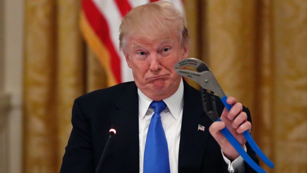 President Donald Trump holds up a Channellock locking plier during a "Made in America," roundtable event in the White House.