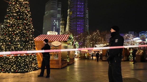 Police guard a Christmas market in Berlin, after a truck ploughed into the crowd.