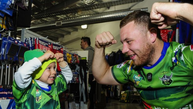 Canberra Raiders prop Shannon Boyd flexes with four-year-old supporter Xander Garrao.