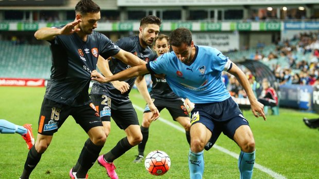 In a tangle: Alex Brosque tries to break free from the Brisbane Roar defence at Allianz Stadium.