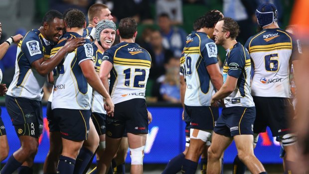 David Pocock celebrates with Brumbies teammates after scoring his third try against the Force.