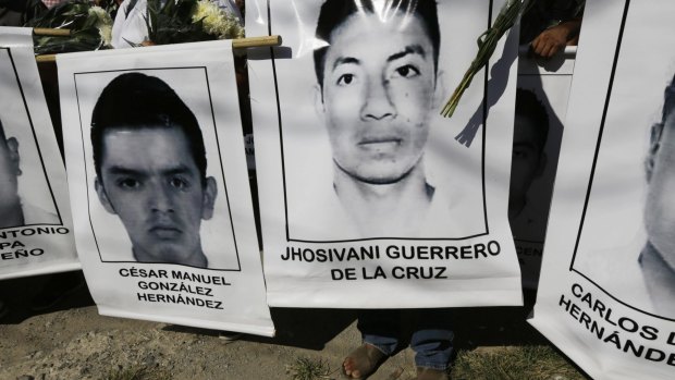 Relatives of the missing students carry their photographs at a march in Iguala in south-west Mexico on Monday.