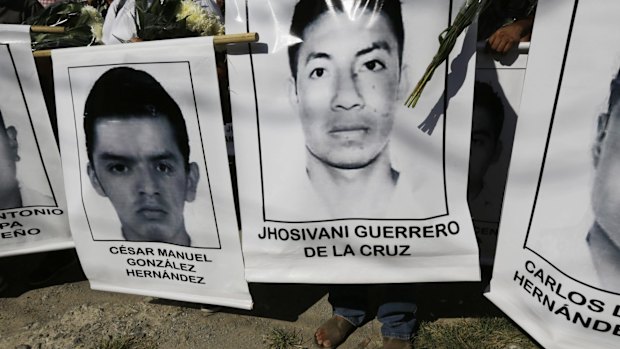 Relatives of the missing students carry their photographs at a march in Iguala in south-west Mexico on Monday.