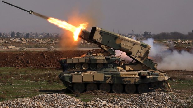 Iraqi government forces launch a rocket against Islamic State militants in Mosul on Sunday.