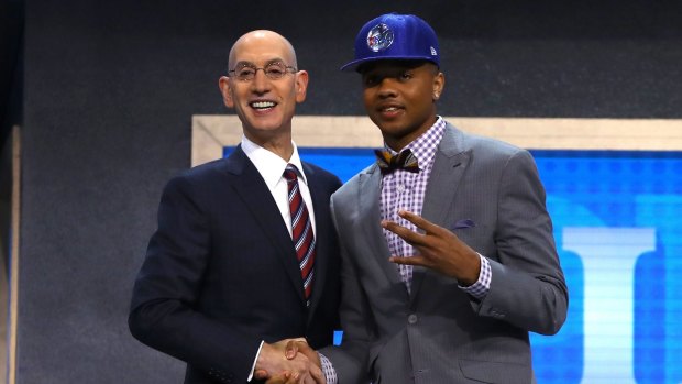 Markelle Fultz walks on stage with NBA commissioner Adam Silver after being drafted first overall by the Philadelphia 76ers.