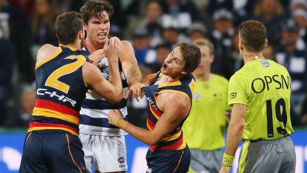 Cop that: The Crows' Matt Crouch reacts to a jumper punch from Tom Hawkins.
