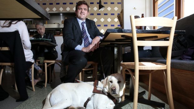 Stephen Fagg of Belconnen with his guide dog Samson at the Cupping Room.