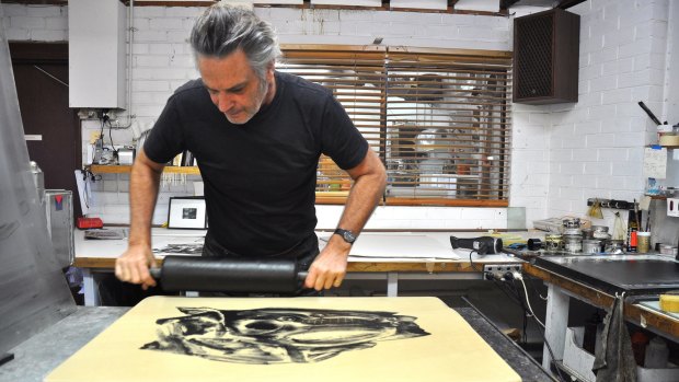 Peter Lancaster works on a lithograph stone.