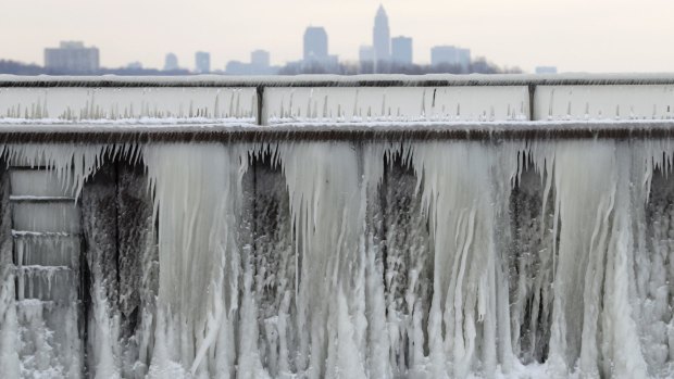 Ice forms on a breakwall along Lake Erie with the city of Cleveland in the background last Wednesday. Dangerously cold temperatures have gripped wide swaths of the US from Texas to New England. 