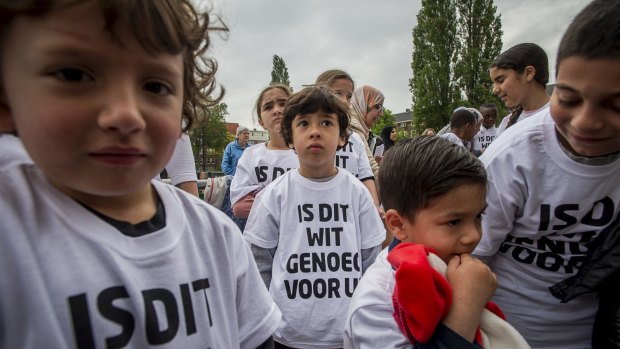 Pupils from a primary school in Amsterdam wear t-shirts that read 'Is this white enough for you?' on Friday.