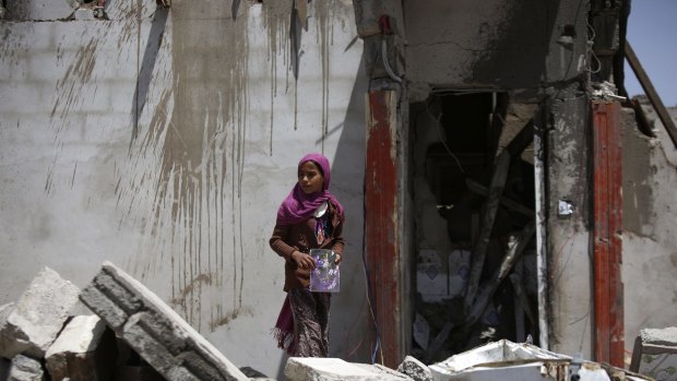 A girl stands in the rubble of a house destroyed by a Saudi-led airstrike on the outskirts of the Yemeni capital Sanaa on Wednesday.
