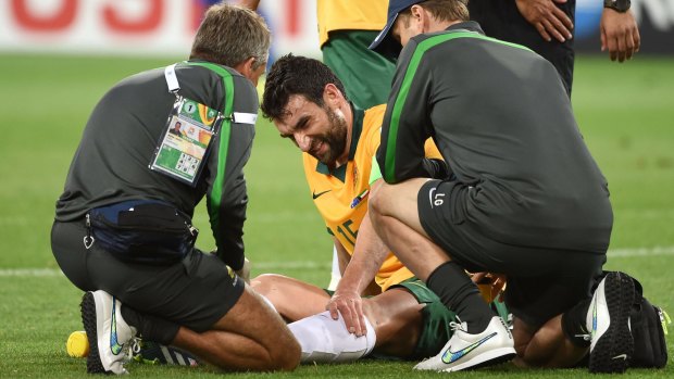 Down and maybe out: Socceroos skipper Mile Jedinak.