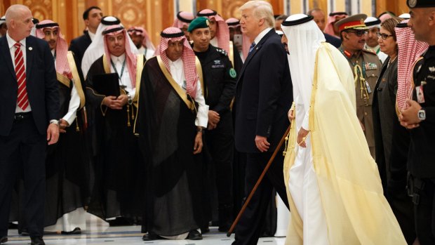 Saudi King Salman and US President Donald Trump arrive at the Arab Islamic American Summit, at the King Abdulaziz Conference Centre, on Sunday.