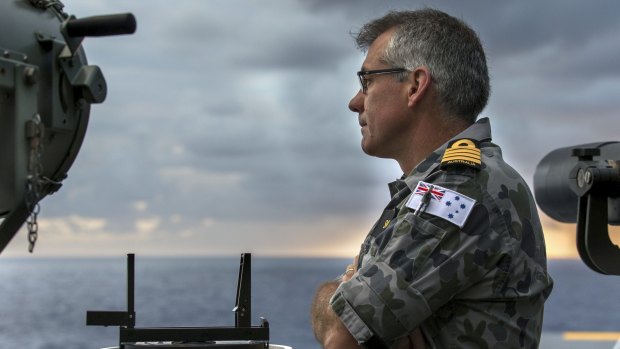 The commanding officer of HMAS Canberra, Captain Christopher Smith, on the bridge wing during Sea Series 2015.