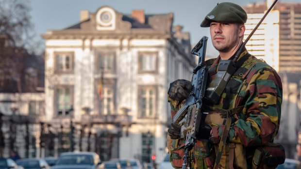 A Belgian commando patrols near the office of the Prime Minister in Brussels at the weekend.