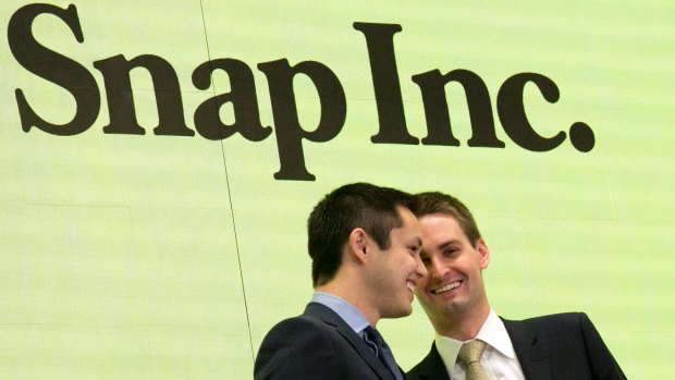 Snapchat co-founders Bobby Murphy, left, and CEO Evan Spiegel ring the opening bell at the New York Stock Exchange as the company celebrates its IPO.