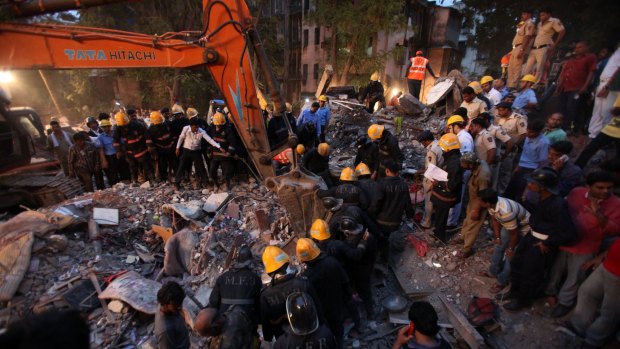 Firefighters carry out search and rescue work for the survivors of a collapsed building in Mumbai on Tuesday evening.