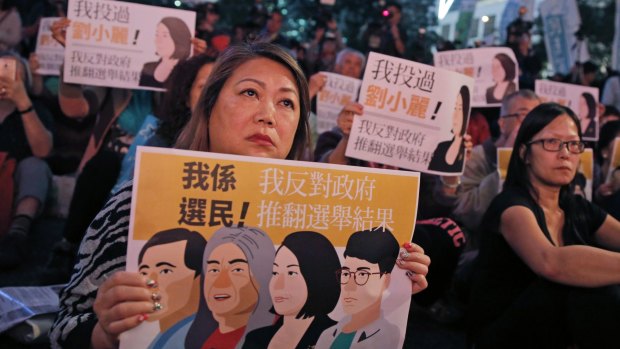 Protesters hold posters featuring the newly elected HK pro-democracy lawmakers of the legislature council, "Long Hair" Leung Kwok-hung, Nathan Law Kwun-chung, Lau Siu-lai and Edward Yiu Chung-yim during a demonstration in Hong Kong on Saturday.