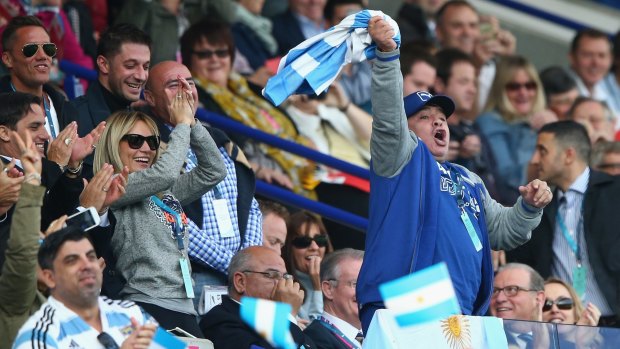 Support:  Diego Maradona celebrates in the stands at the rugby World Cup.