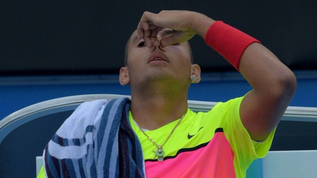 Nick Kyrgios waits to receive treatment for a nosebleed during his third-round match against Tunisia's Malek Jaziri on Friday.