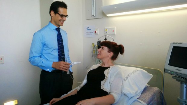 QIMR Berghofer scientist Dr Manuel Ferreira tests Madeleine Flynn's lung capacity.