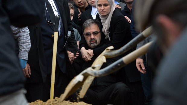 Namee Barakat sits during funeral services for his son,  Deah Shaddy Barakat.