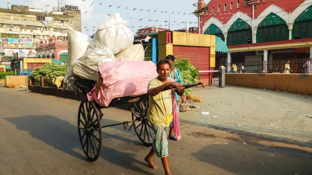 A Kolkata rickshaw puller hauling goods. 