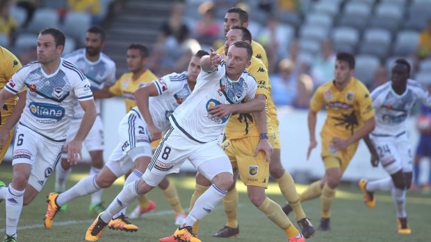 Goal rush: Victory striker Besart Berisha tries to escape the attention of Central Coast's defence.