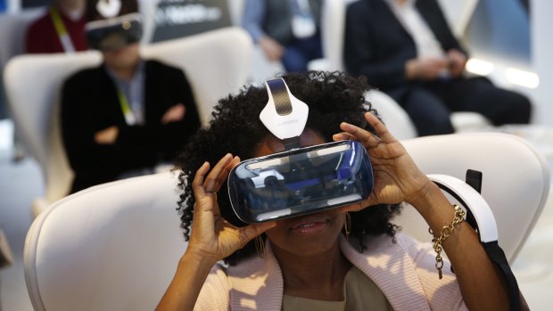 Attendees use Samsung's Galaxy Gear VR headset at CES.