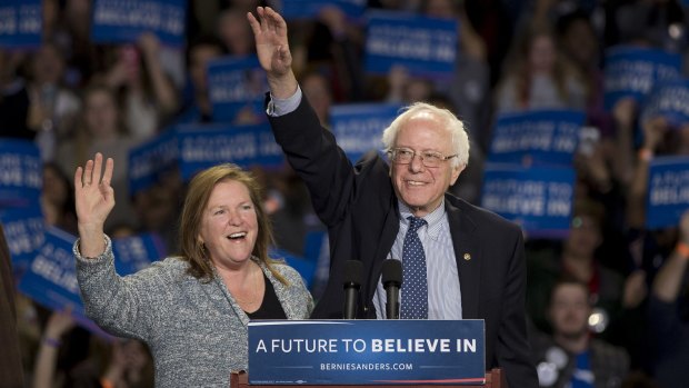 Democratic presidential candidate Bernie Sanders, and his wife Jane, wave to supporters during a rally on Sunday.