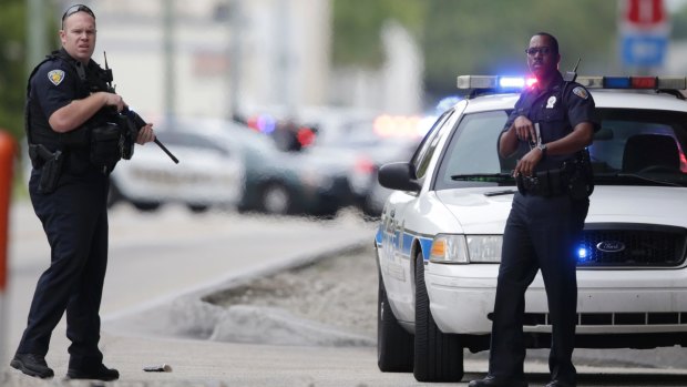 Police officers stand on the perimeter road along the Fort Lauderdale-Hollywood International Airport.