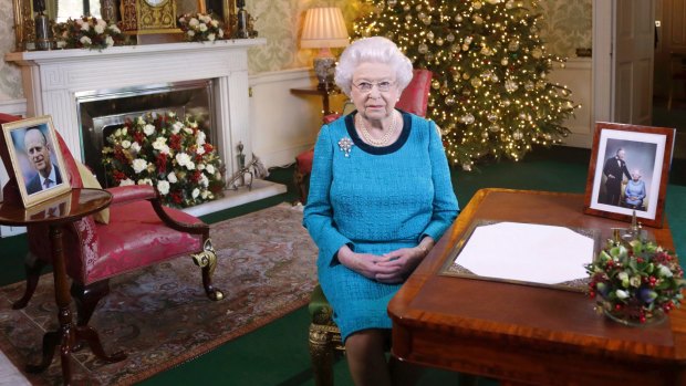 Queen Elizabeth II poses for a photo in the Regency Room of Buckingham Palace after recording her traditional Christmas Day broadcast to the Commonwealth.