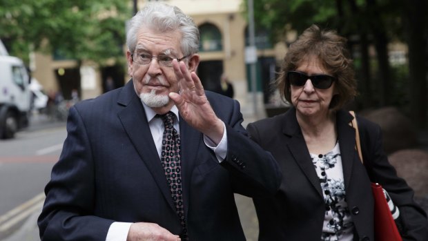 Rolf Harris, left, gestures as he arrives at Southwark Crown Court with his niece Jenny Harris on Monday.