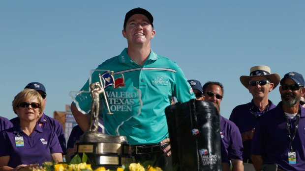 Jimmy Walker poses with the Valero Texas Open trophy.