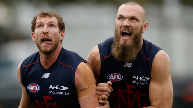 Melbourne's Jake Spencer (left) and Max Gawn battle it out in a ruck contest during training on Wednesday.