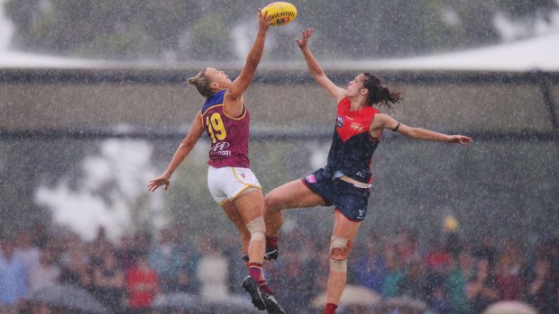 Lions ruck Selina Goodman wins a tap in the downpour.