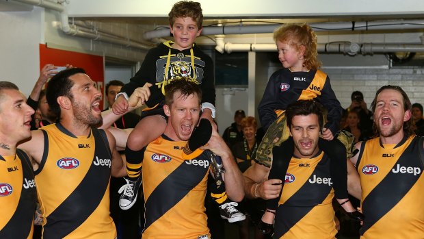 Highs and lows: The Tigers sing the club song after beatin Fremantle.