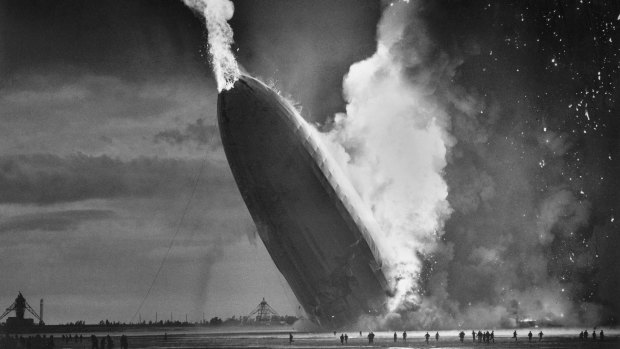 The German dirigible Hindenburg crashes to the ground, tail first, in flaming ruins after exploding on May 6, 1937. 
