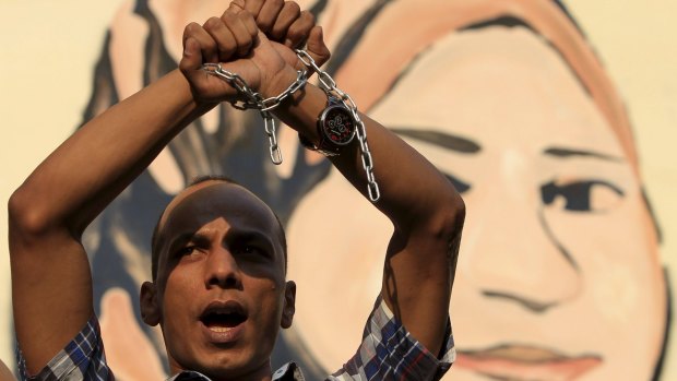 A protester holds up his hands, as journalists and members of the April 6 movement protest against the restriction of press freedom and demand the release of detained journalists in Cairo in June.