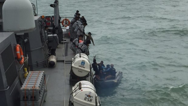 An Indonesian Navy seaboat picks up items retrieved from the Republic of Singapore Navy vessel RSS Valour. 