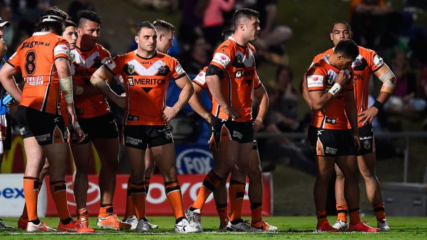 Dejected: Wests Tigers players stand in goal awaiting a conversion attempt after one of the Cowboys' 12 tries on Saturday night.