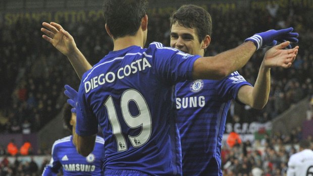 Blue tide: Oscar celebrates his second goal with Diego Costa. 