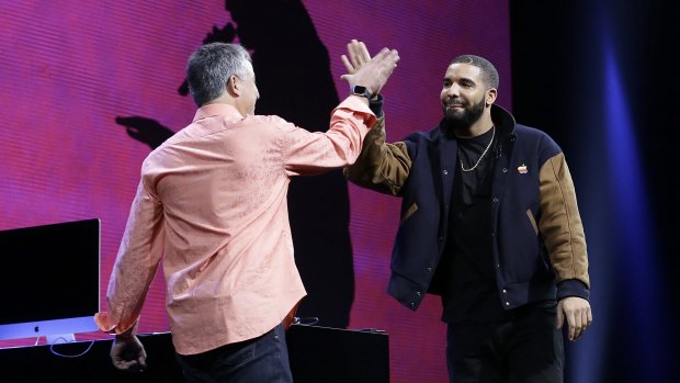 Canadian rapper Drake high-fives Eddy Cue, Apple senior vice-president of Internet Software and Services, at the Apple Music launch.