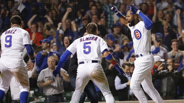 Chicago Cubs' Jason Heyward, right, celebrates his game-winning grand slam off Philadelphia Phillies relief pitcher Adam Morgan during the ninth inning of a baseball game on June 6, 2018. 