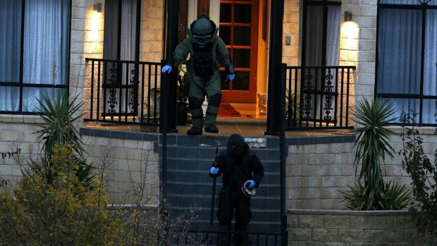 Bomb squad officers at the Melbourne property on Friday night.